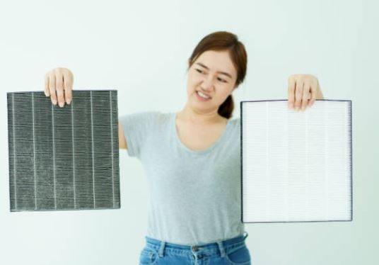 User replacing Medify Air Filter on the MA-40 air purifier to maintain performance.